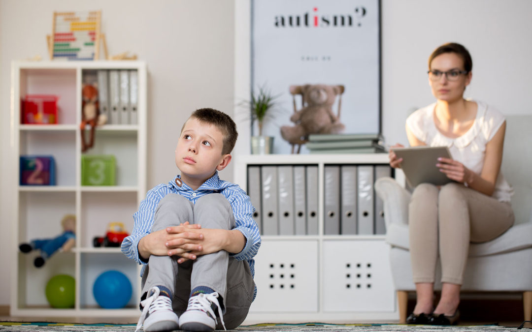 autistic child with therapist